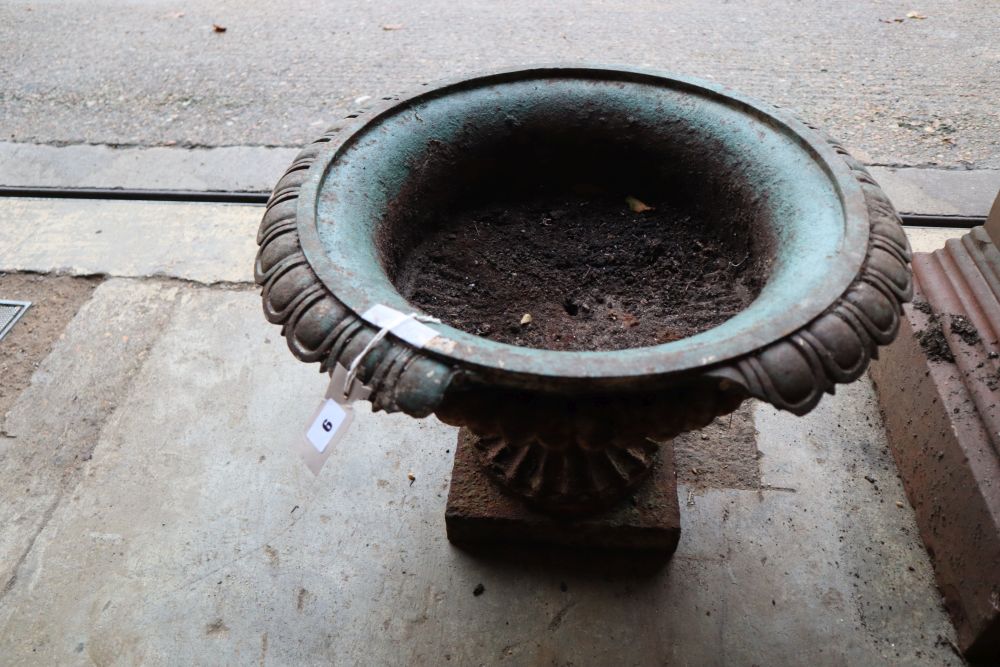 A Victorian cast iron campana garden urn on plinth, 52cm diameter, height 34cm